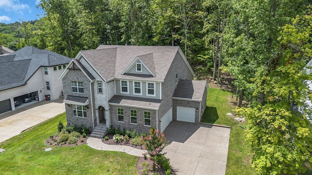 view of front of home with a garage and a front lawn