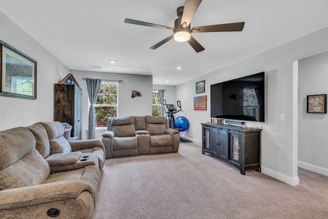 carpeted living room featuring ceiling fan