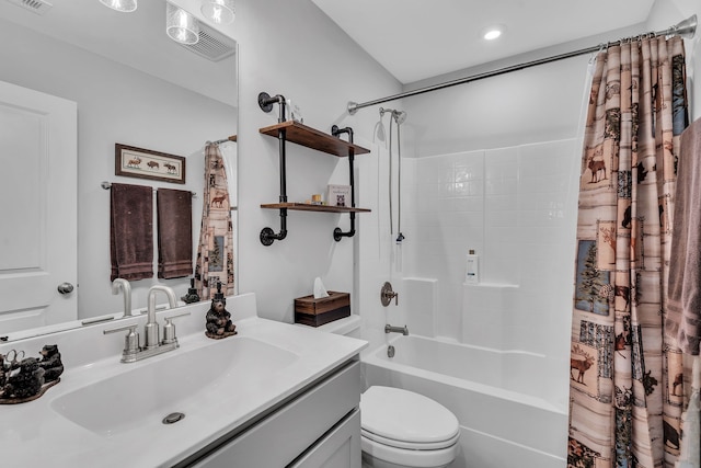 full bathroom featuring vanity, shower / bath combo with shower curtain, and toilet