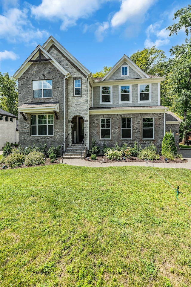 craftsman-style home featuring a front lawn