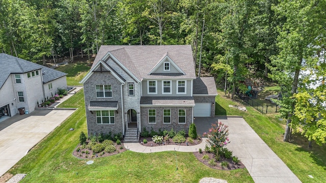 view of front of home with a garage and a front lawn