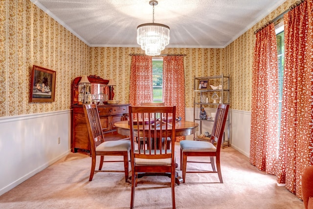 dining space featuring carpet floors, wainscoting, a notable chandelier, and wallpapered walls