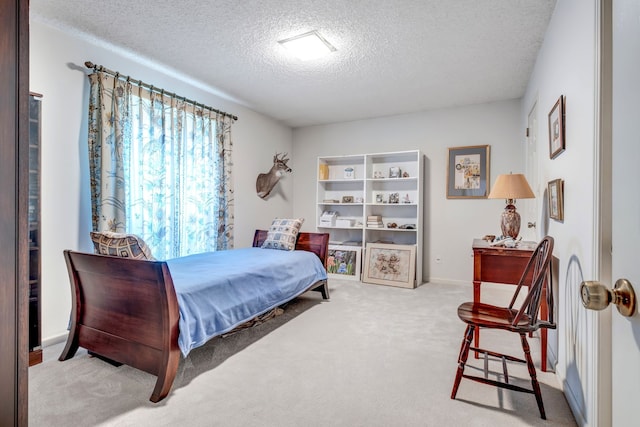 bedroom with carpet floors, a textured ceiling, and baseboards