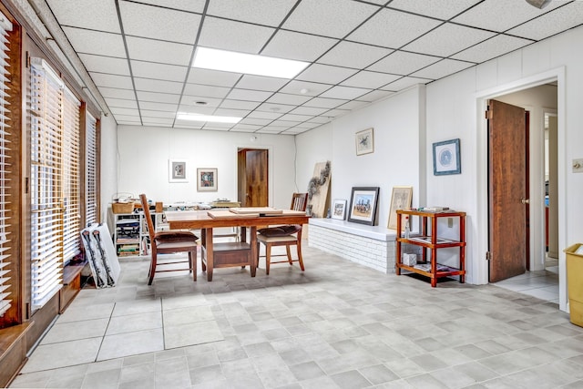 dining area featuring a paneled ceiling