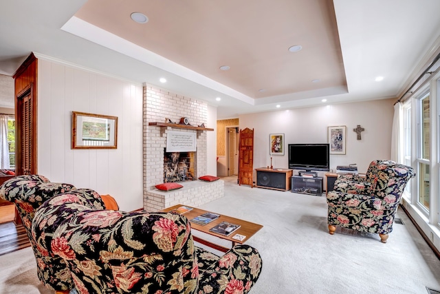 living room featuring carpet, recessed lighting, a raised ceiling, visible vents, and a brick fireplace