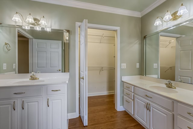 bathroom with hardwood / wood-style floors, vanity, and crown molding