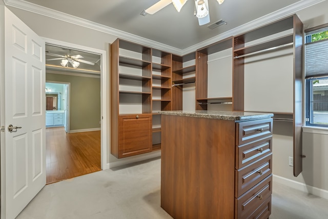 spacious closet featuring light hardwood / wood-style flooring and ceiling fan