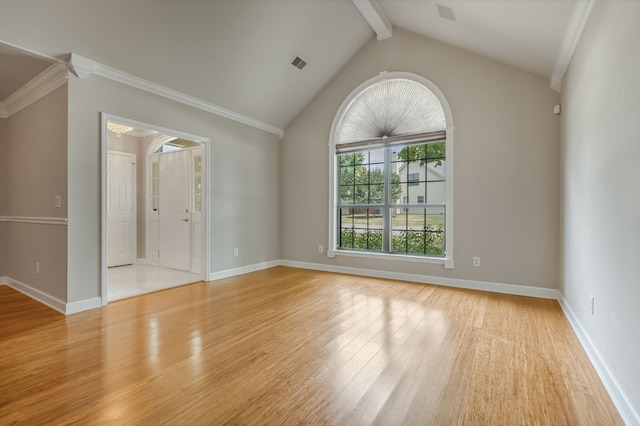 unfurnished room featuring ornamental molding, light hardwood / wood-style floors, and vaulted ceiling with beams