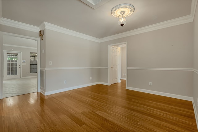 unfurnished room with wood-type flooring and crown molding