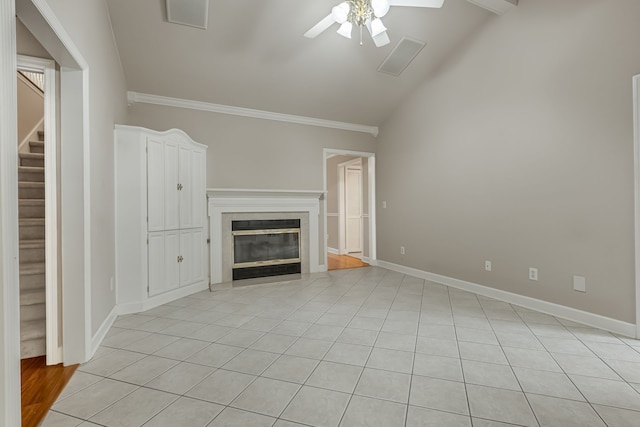 unfurnished living room with ceiling fan, crown molding, vaulted ceiling, and light tile patterned floors