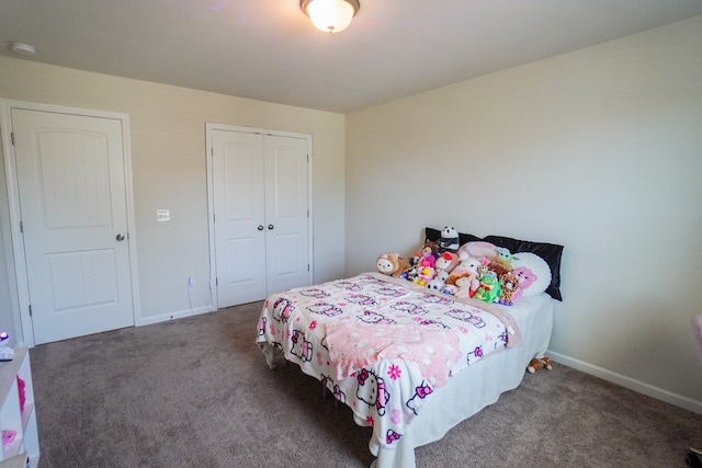 bedroom with dark colored carpet and a closet