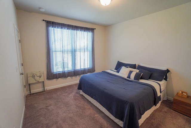 bedroom with dark colored carpet