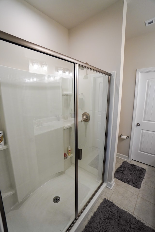 bathroom featuring tile patterned floors and an enclosed shower