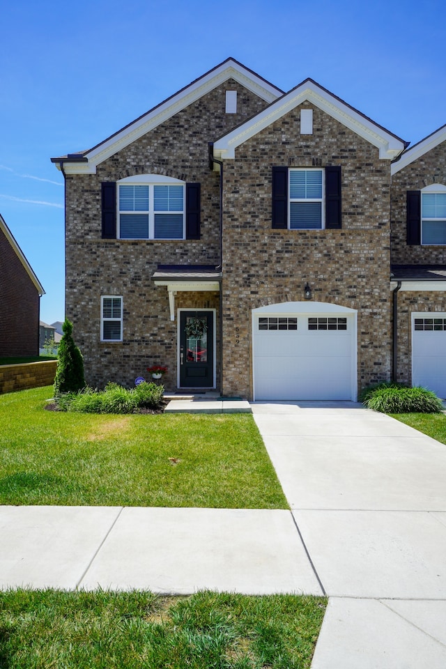 view of front of home with a garage and a front lawn