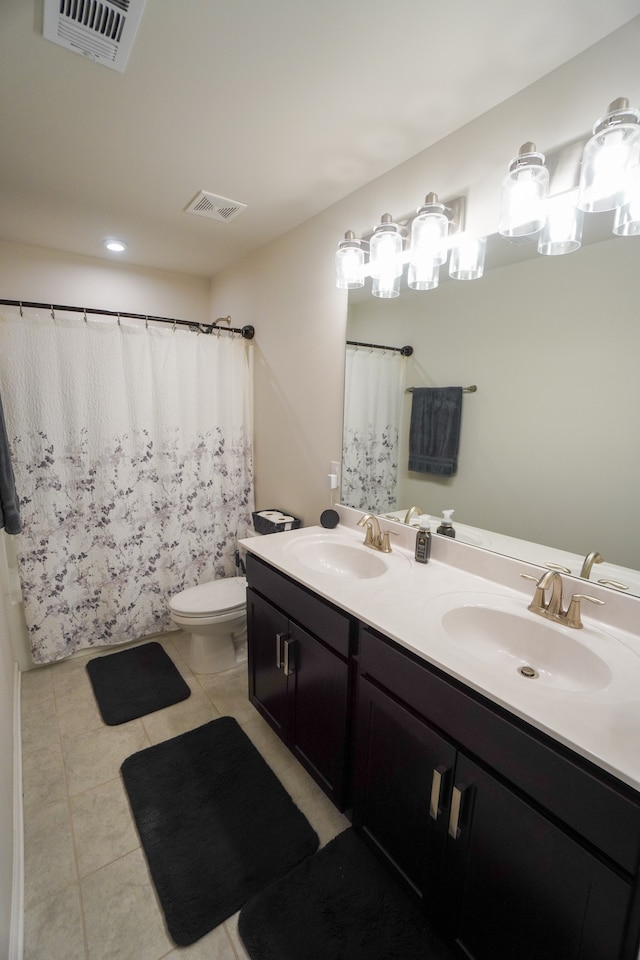 bathroom with vanity, tile patterned flooring, and toilet