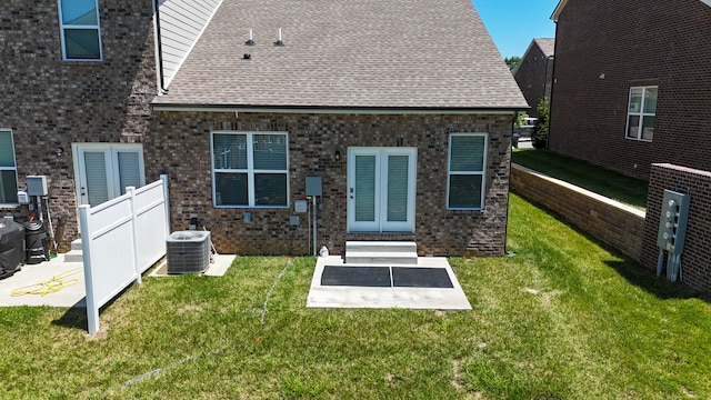 back of house featuring central AC unit, a yard, and a patio area