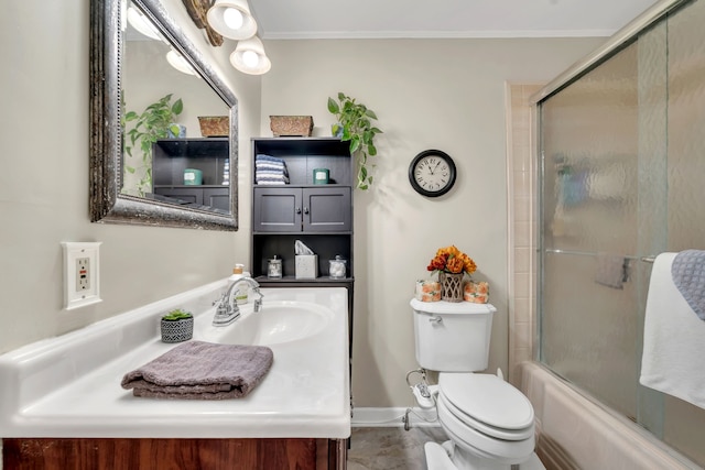 full bathroom featuring ornamental molding, combined bath / shower with glass door, vanity, tile patterned floors, and toilet