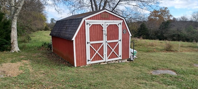 view of outbuilding with a lawn