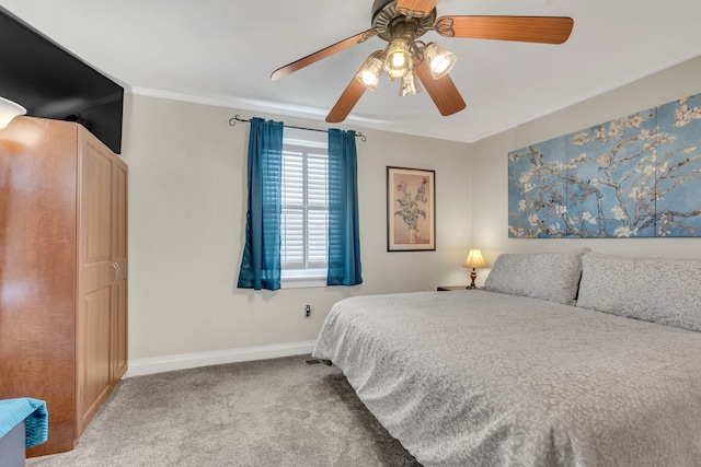 carpeted bedroom featuring ceiling fan and ornamental molding