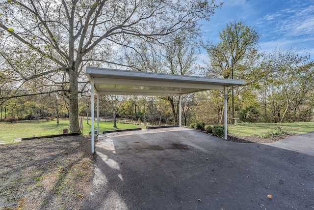 view of car parking with a yard and a carport