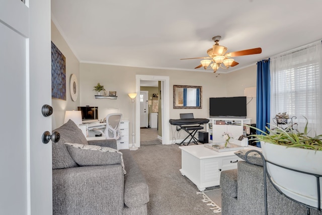 carpeted living room featuring ceiling fan and ornamental molding