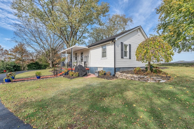 view of side of home with a yard