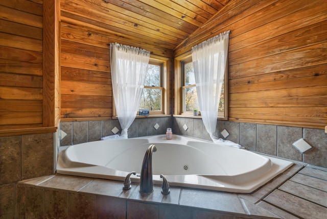 bathroom featuring a relaxing tiled tub, wooden ceiling, and vaulted ceiling