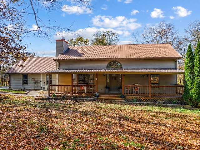 187 Th Hooper Ln, Mc Ewen, TN 37101 - rear view of property with a chimney, metal roof, and a porch
