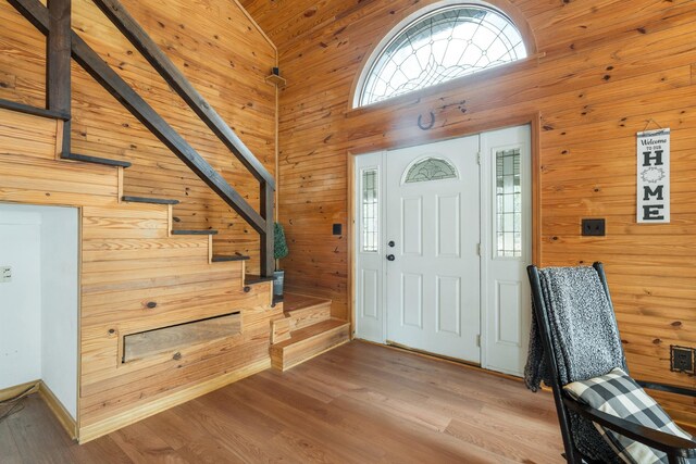 187 Th Hooper Ln, Mc Ewen, TN 37101 - foyer with wood walls, wood finished floors, stairs, and high vaulted ceiling