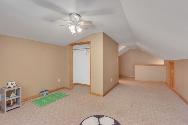 additional living space with lofted ceiling, light carpet, and ceiling fan