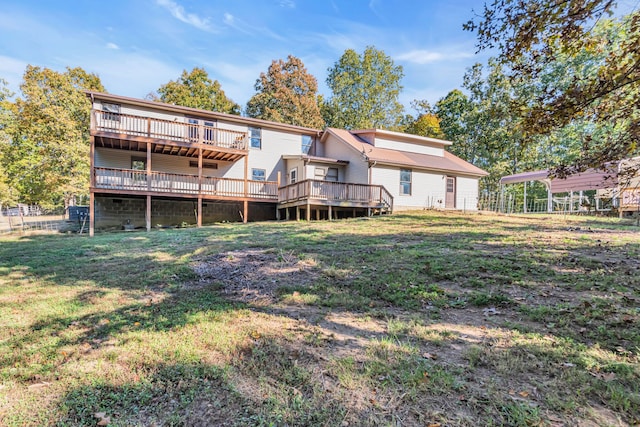 rear view of property with a wooden deck and a yard