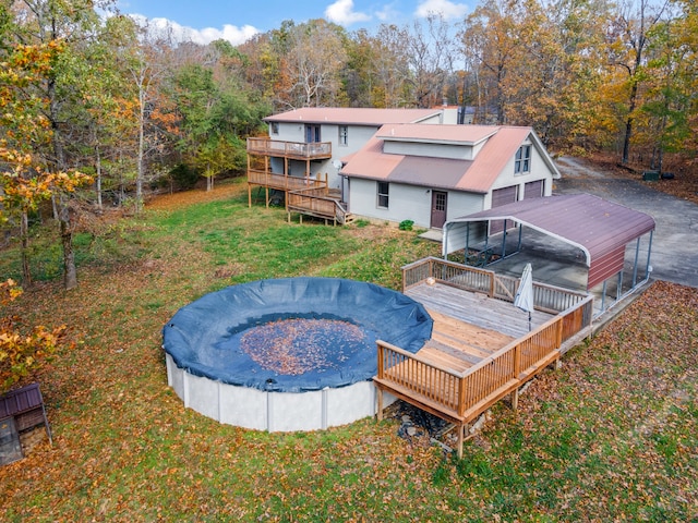 back of property featuring a lawn and a swimming pool side deck