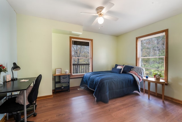 bedroom with ceiling fan and dark hardwood / wood-style floors