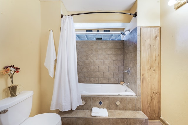 bathroom featuring shower / bath combo and toilet