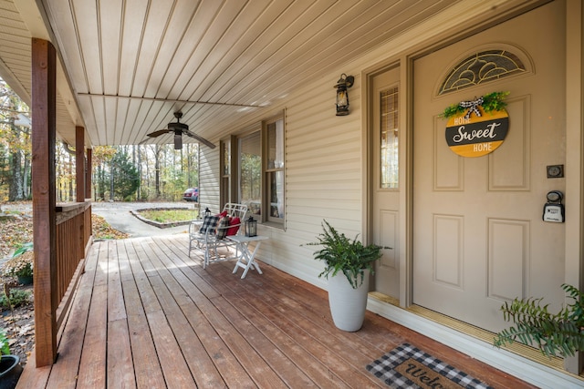 wooden deck featuring covered porch and ceiling fan