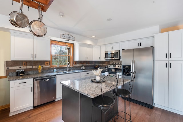 kitchen with white cabinetry, a center island, and stainless steel appliances