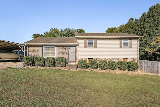 tri-level home with a front yard and a carport