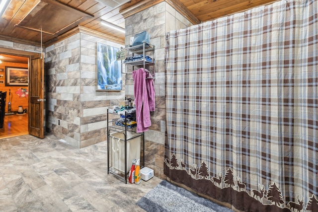 bathroom featuring wooden ceiling, wooden walls, and tile walls