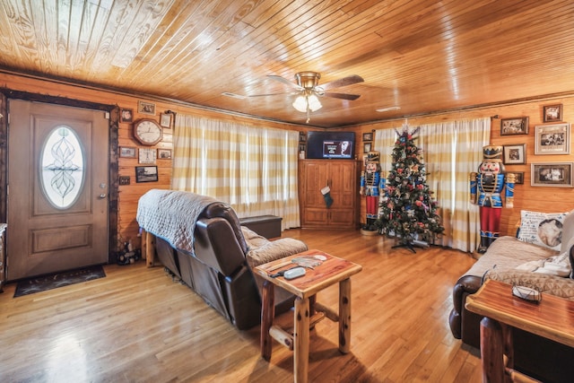 living room with wood walls, wooden ceiling, and light hardwood / wood-style floors