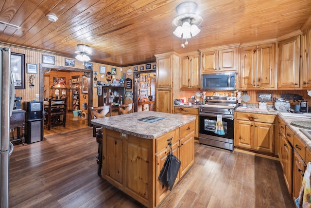 kitchen with stainless steel appliances, dark wood-type flooring, a kitchen island, and wood ceiling