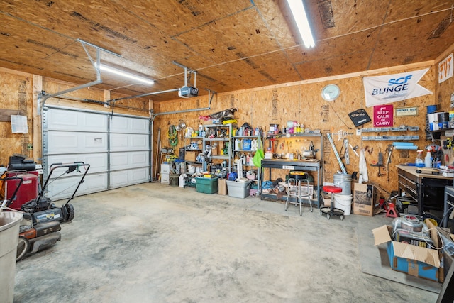 garage featuring a garage door opener and a workshop area