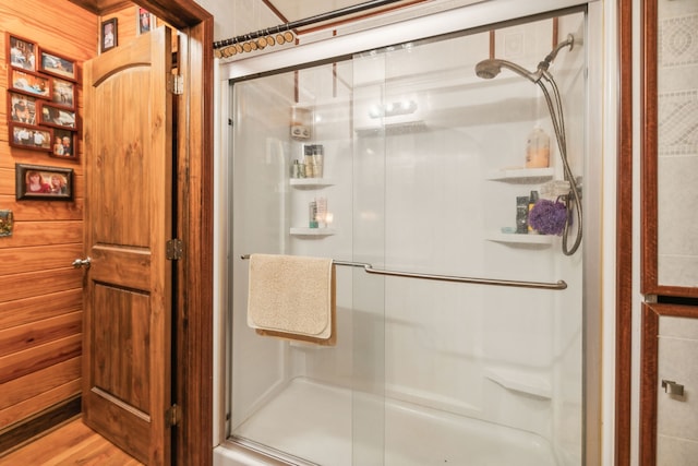 bathroom featuring hardwood / wood-style flooring and a shower with door