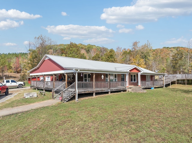 view of front of house with a front yard and a deck