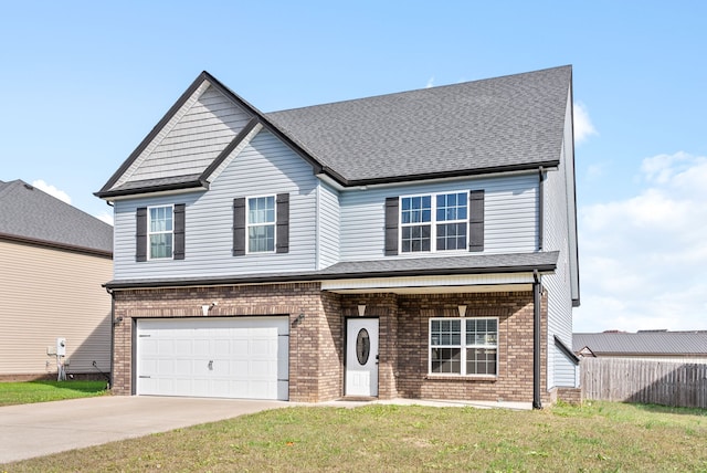 view of front of home featuring a front yard and a garage