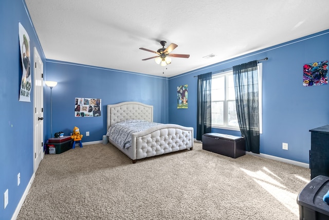 bedroom featuring a textured ceiling, ceiling fan, carpet floors, and crown molding