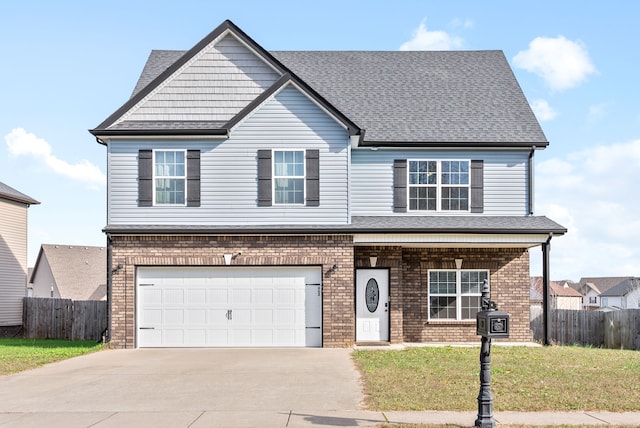 view of front of home with a front lawn and a garage