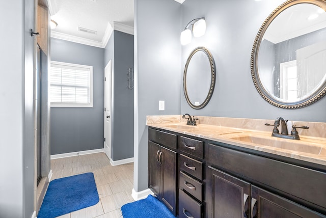 bathroom featuring tile patterned flooring, vanity, a shower with door, and crown molding