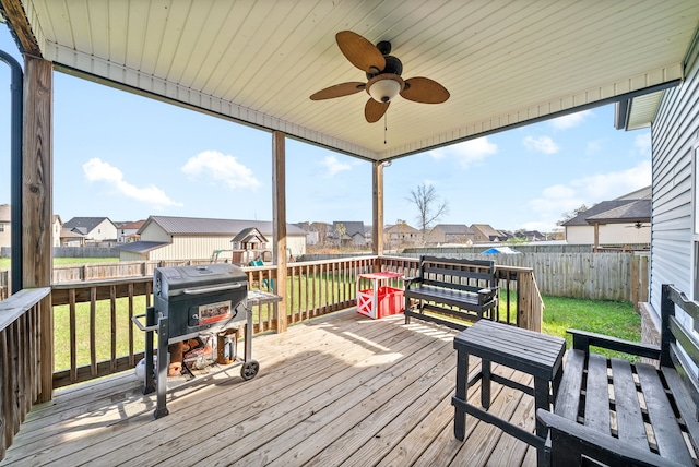 deck with a yard, area for grilling, and ceiling fan