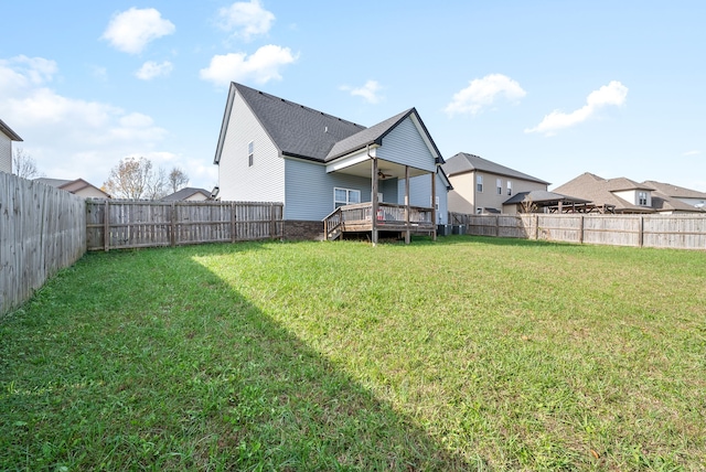 back of property with a yard and a deck