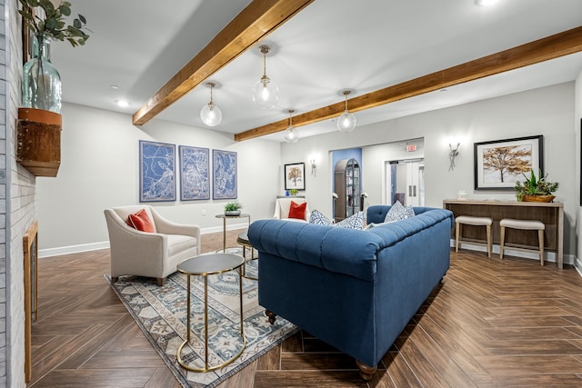 living room featuring dark parquet floors, beam ceiling, and a fireplace